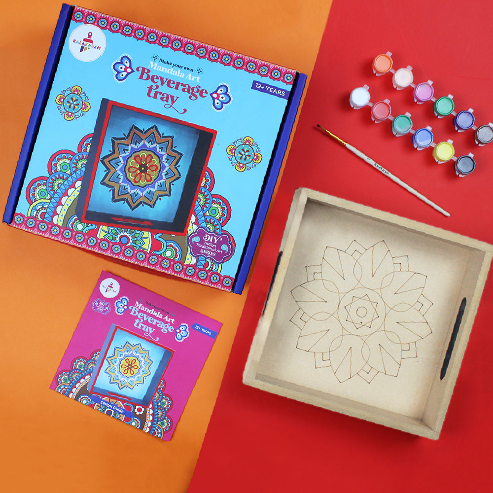 A ready-to-paint wooden mandala art beverage tray kit with pre-etched designs, along with colorful paints and a paintbrush, displayed on a red and orange background.